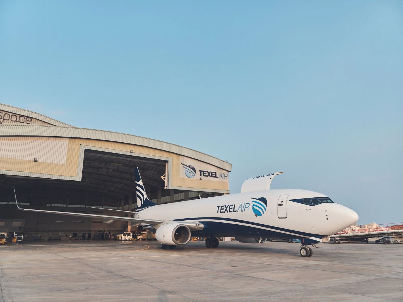 A Texel Air 737-800BCF parked in front of its hangar.
