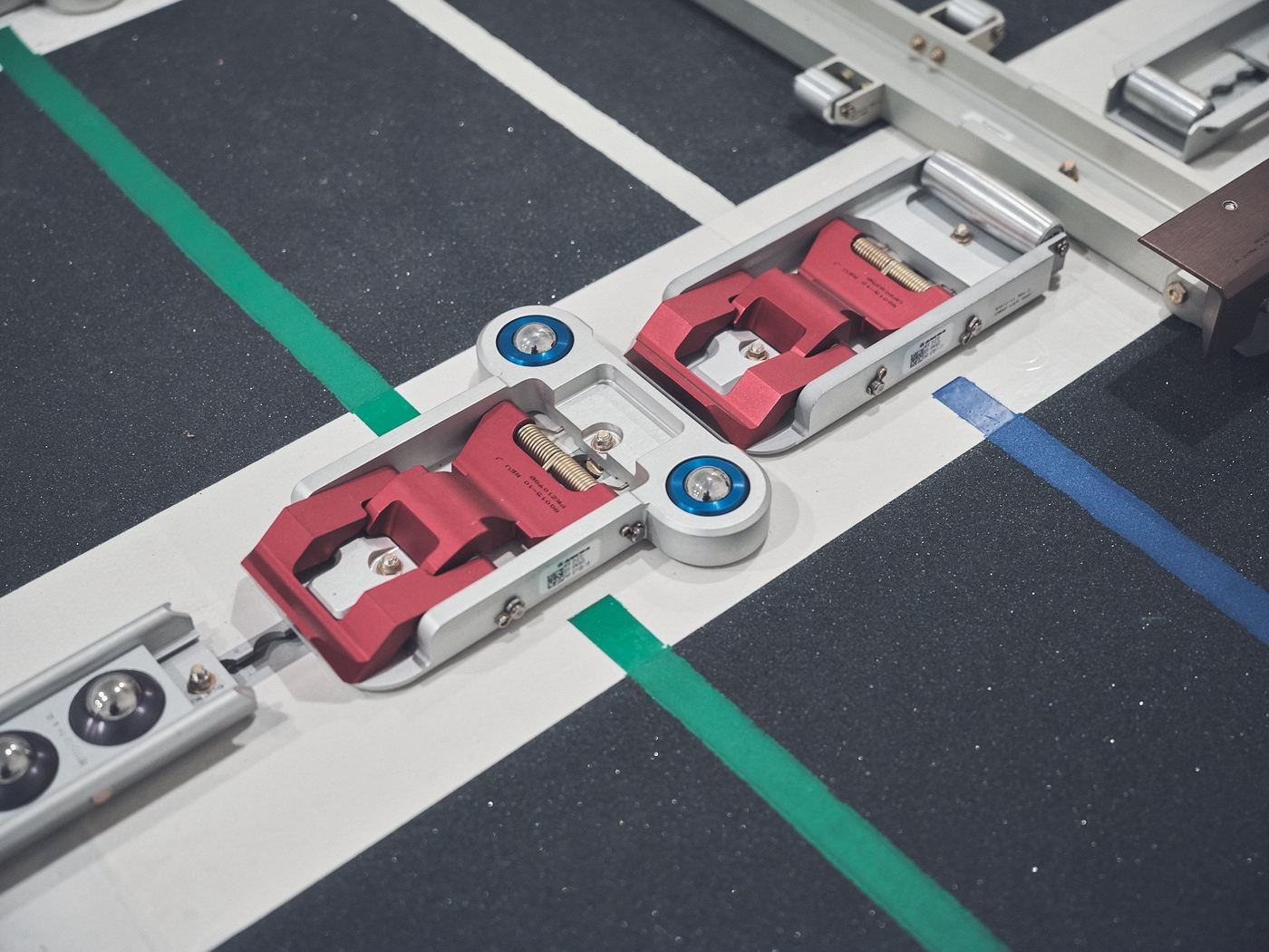 Close view of red cargo floor locks and guide rails.