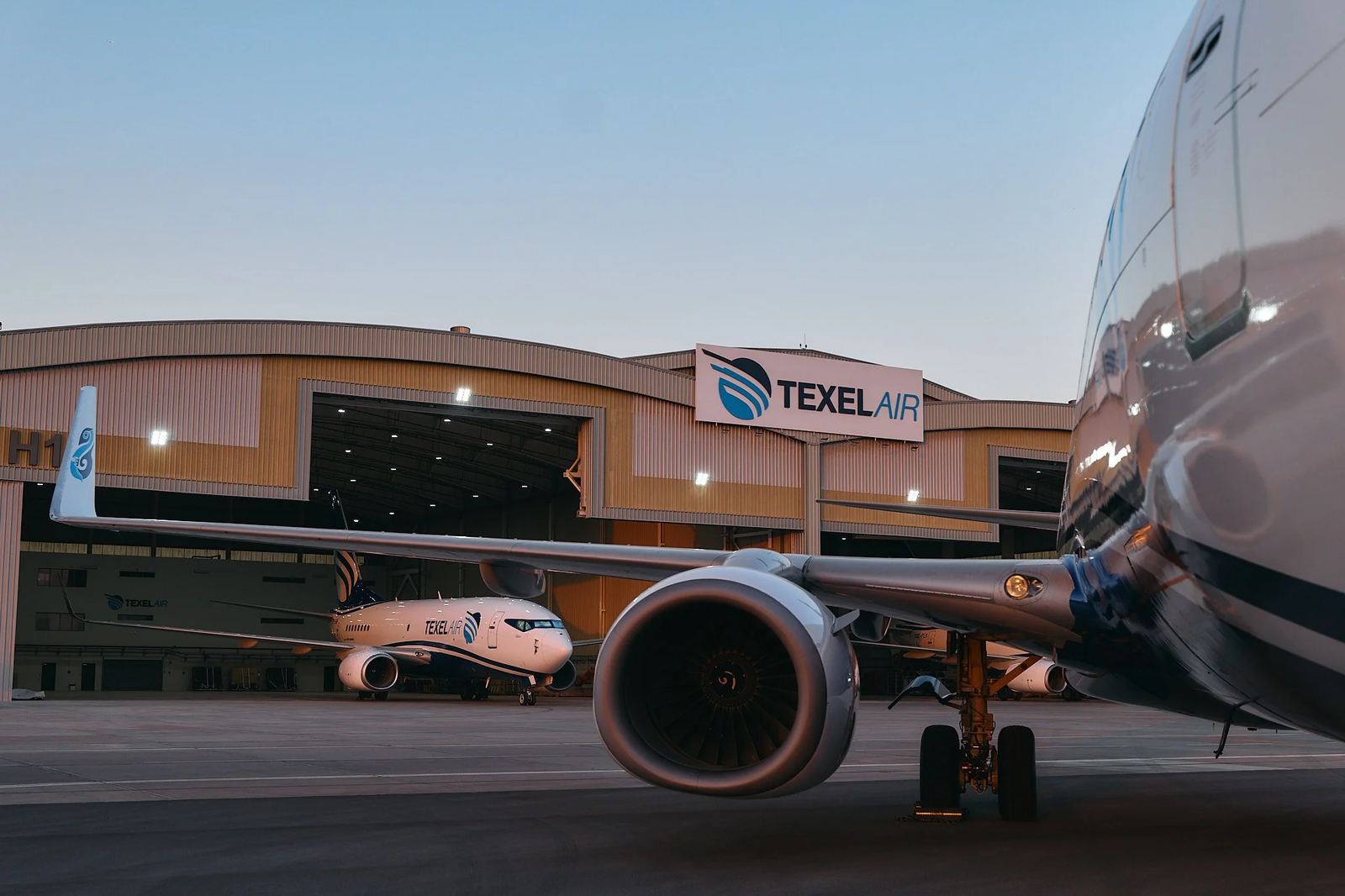 A Texel Air 737 in front of the Texel Air hangar at dawn.